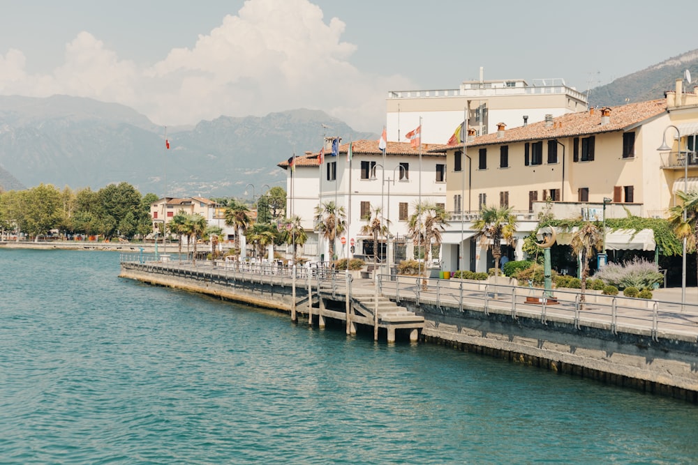 a body of water next to a row of buildings