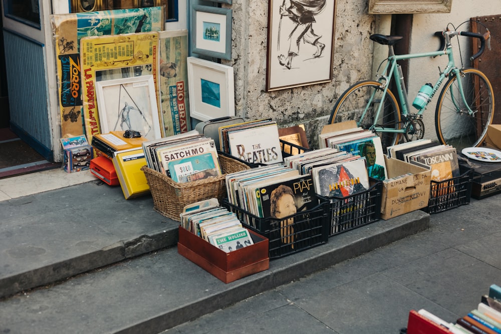 a bicycle parked next to a building with a bunch of books on it