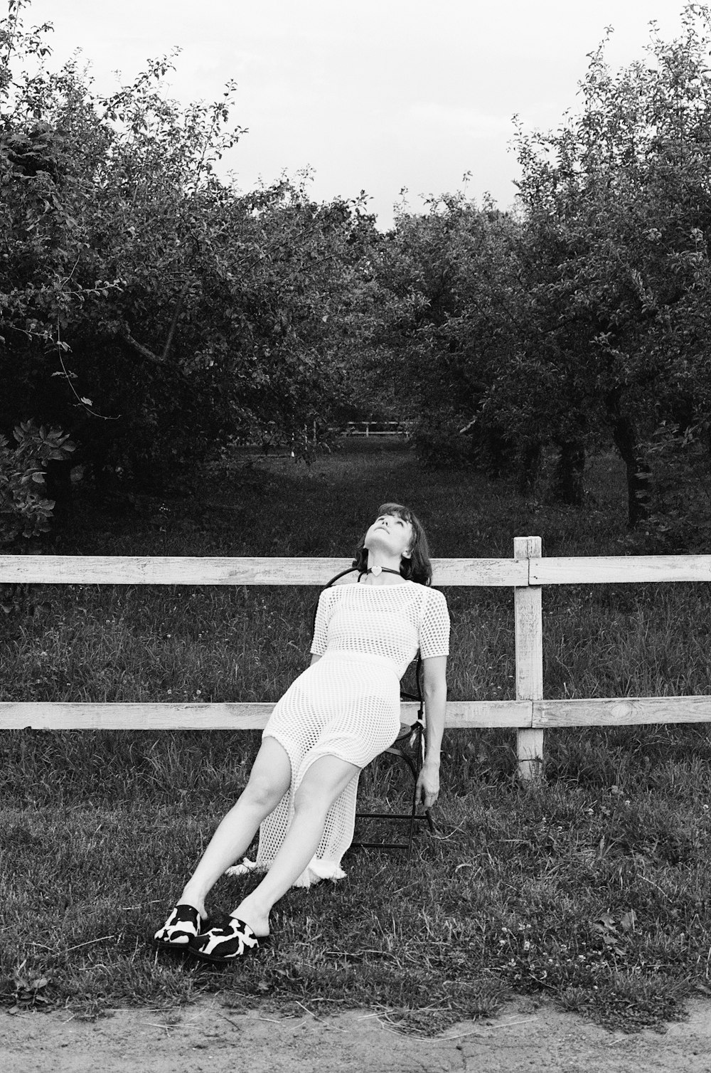 a woman laying on a chair in a field