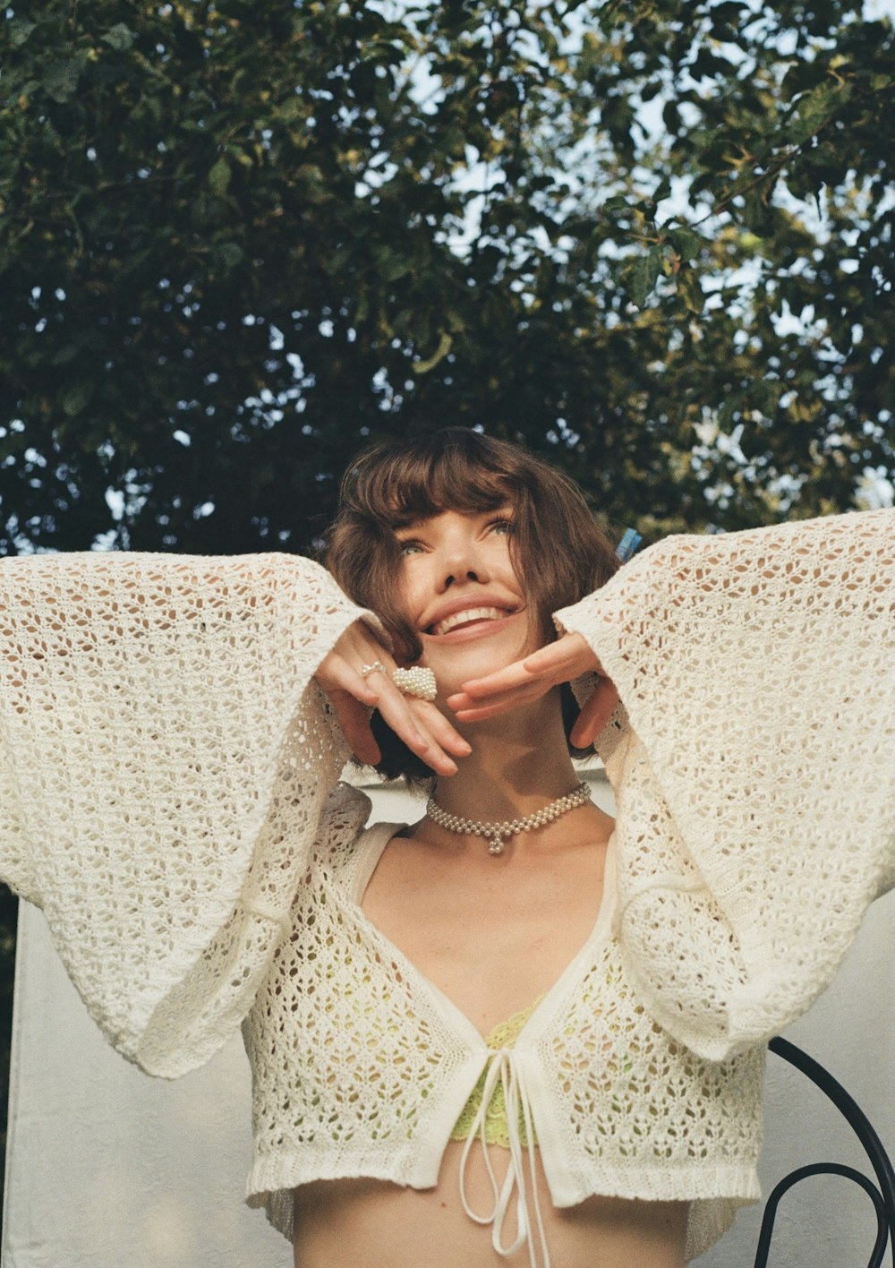 a woman wearing a white crochet crop top