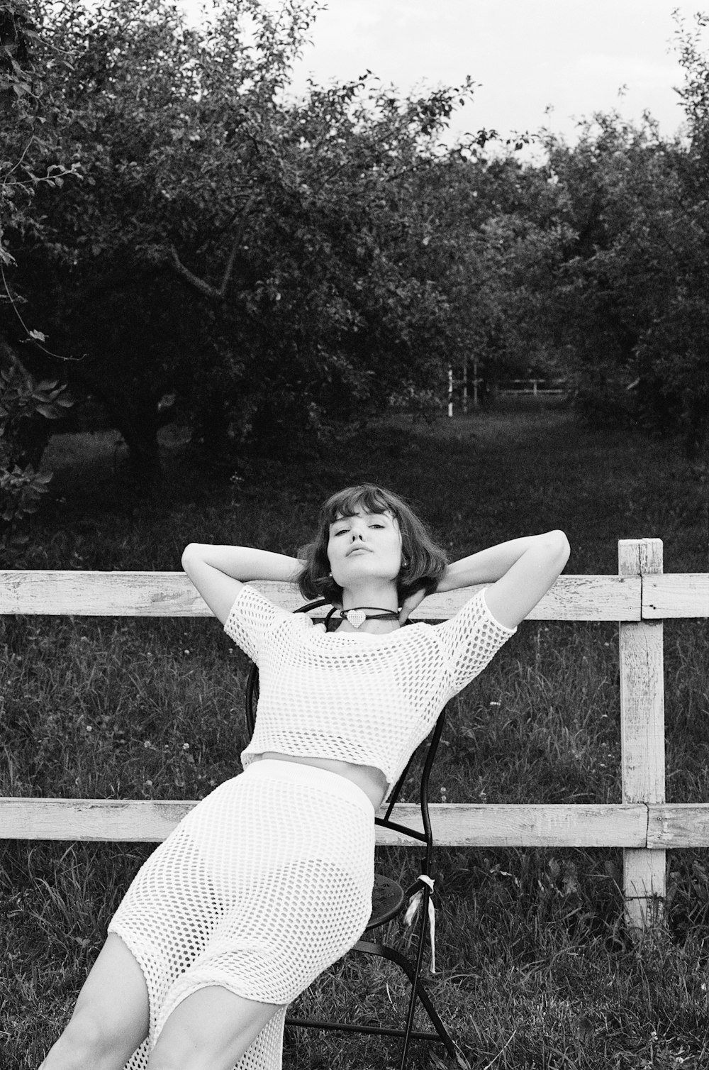 a woman laying on a chair in a field
