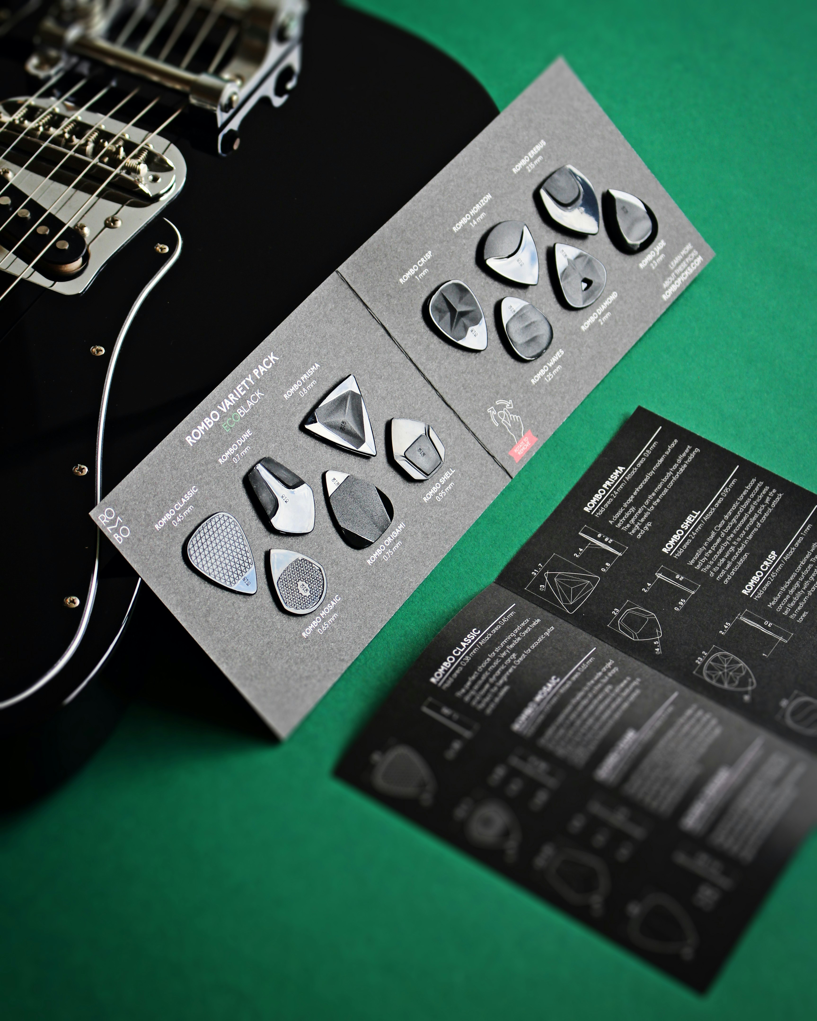 a close up of a guitar picker near a guitar