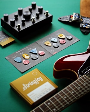 a guitar, a book, and other musical instruments on a table
