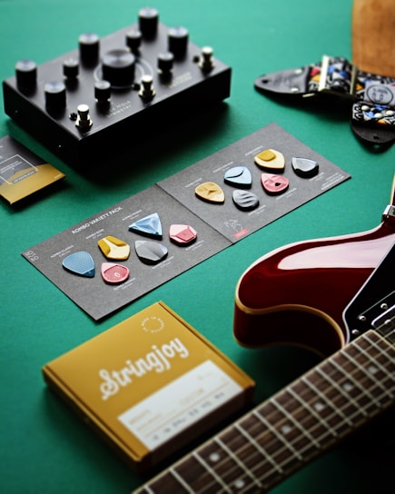 a guitar, a book, and other musical instruments on a table