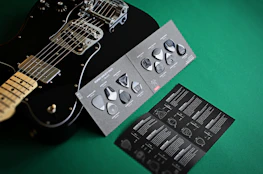 Happy student receiving a rented guitar package with a verified seller badge.