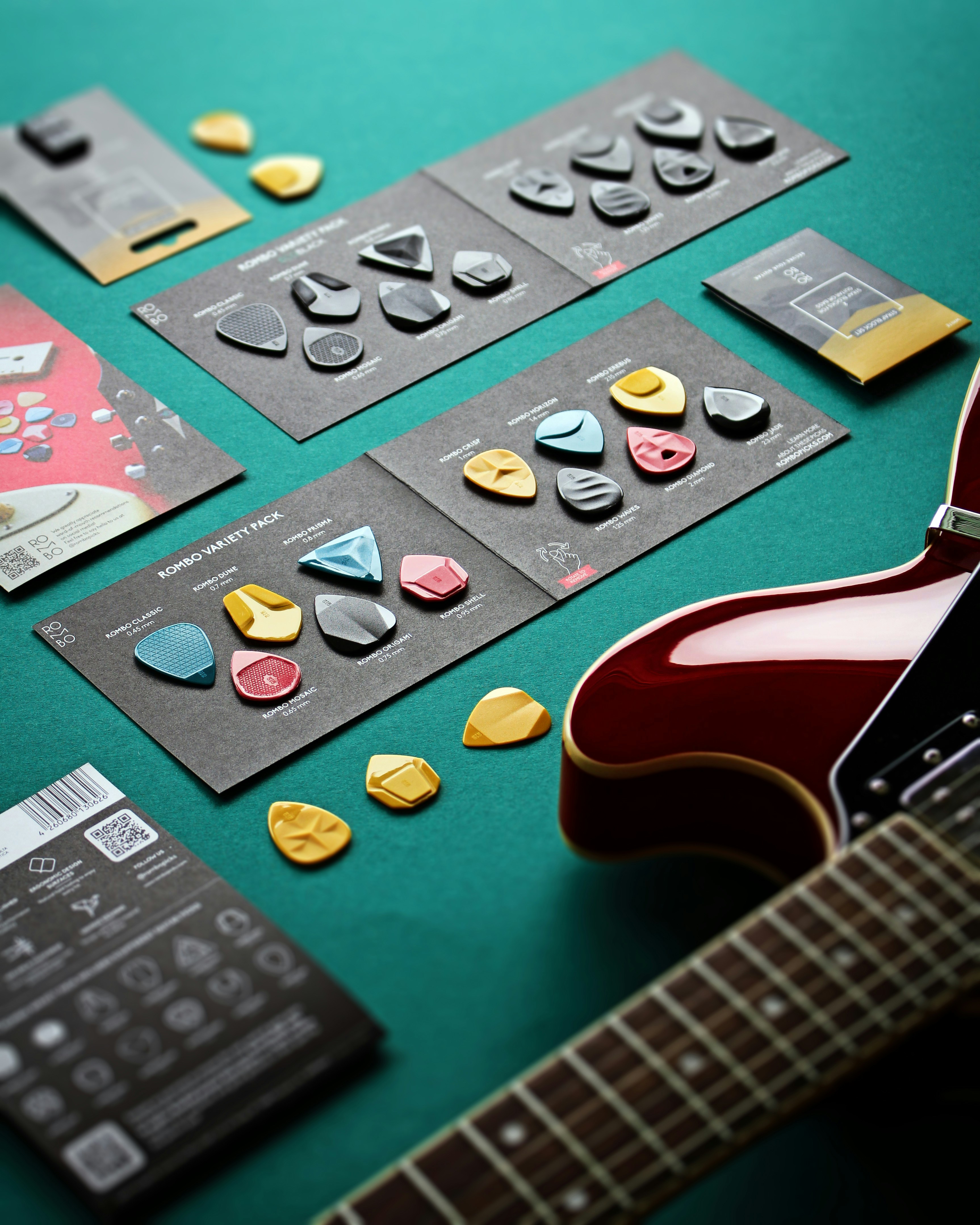 a guitar and some buttons on a table