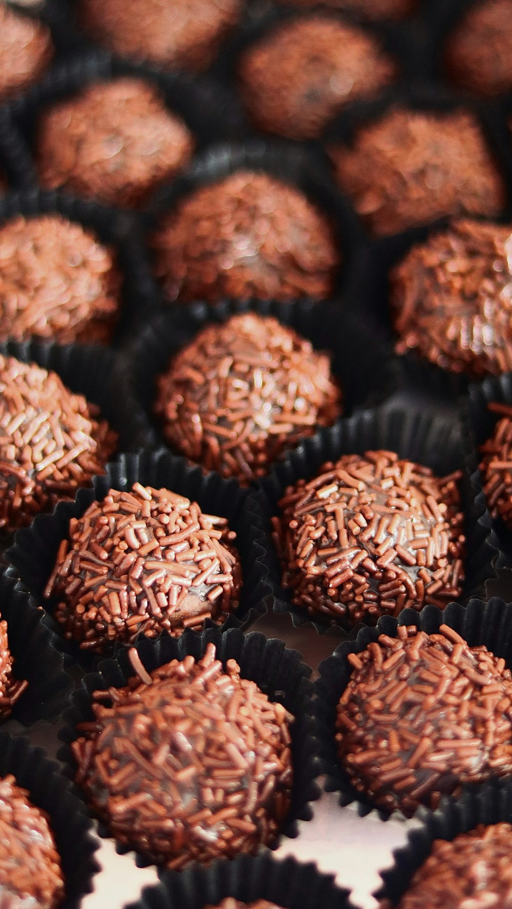 a close up of a tray of chocolates