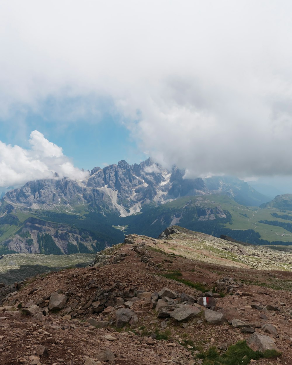 a view of a mountain range with rocks and grass