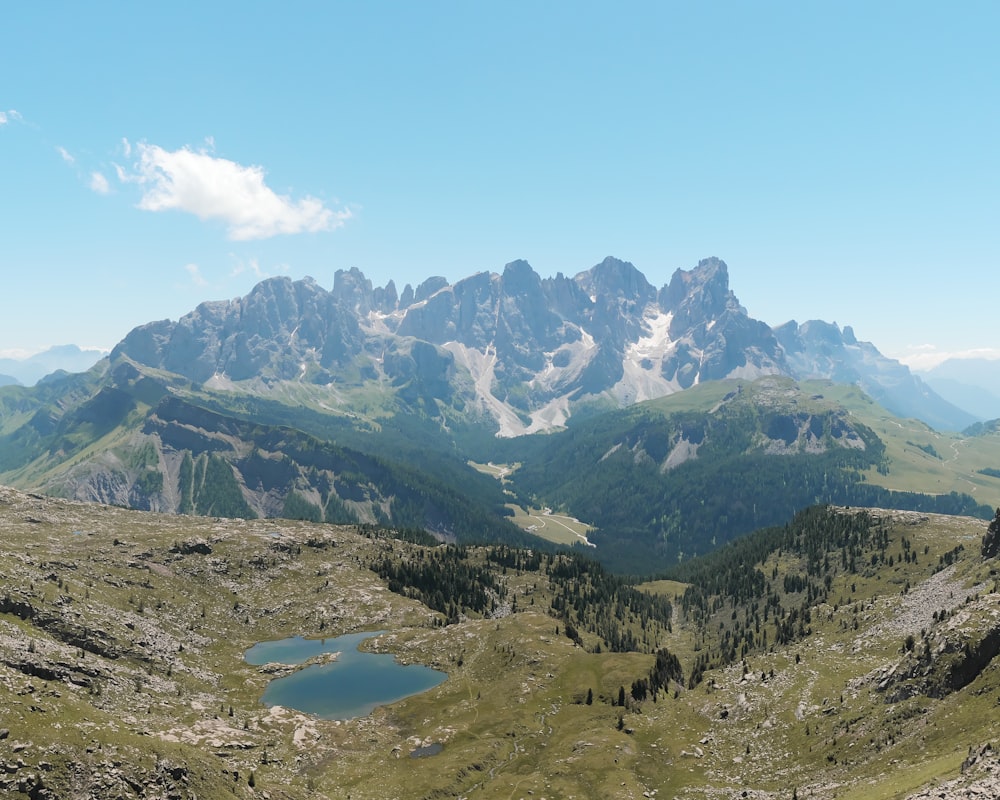 a view of a mountain range with a lake in the foreground