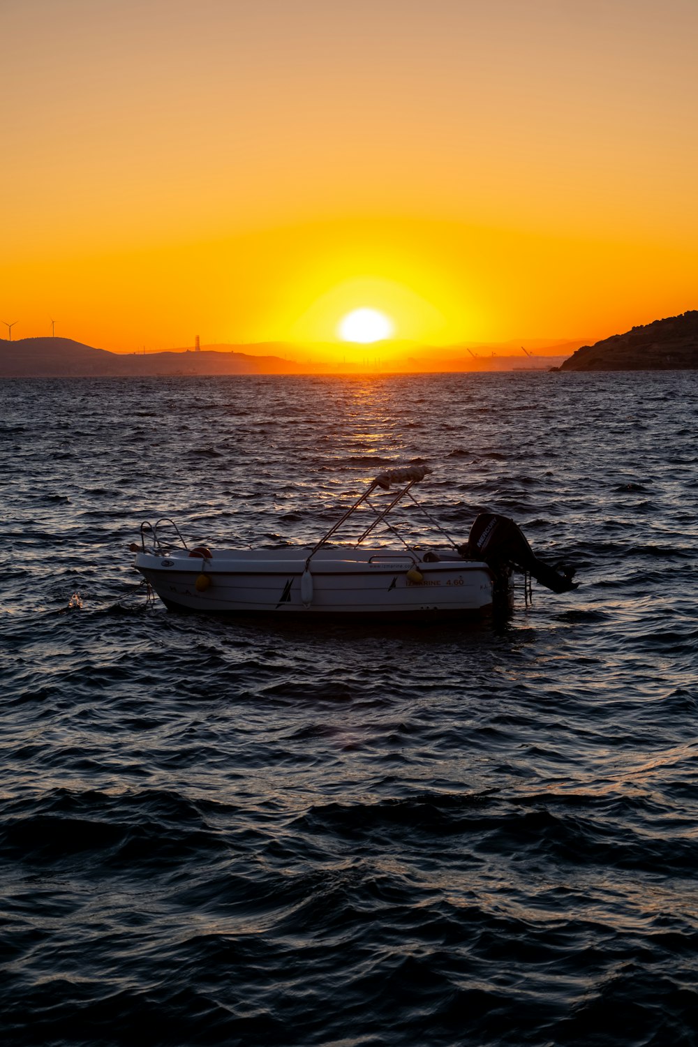 a small boat floating on top of a body of water