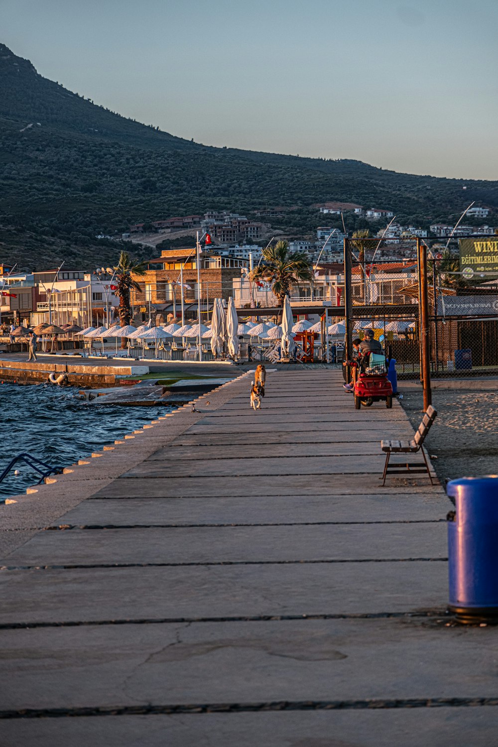 a long dock with people sitting on it