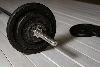 a close up of a barbell on a wooden floor