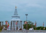 a large white building with many flags around it