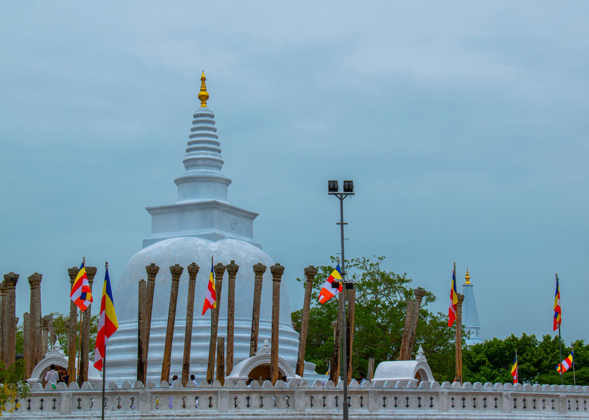 a large white building with many flags around it