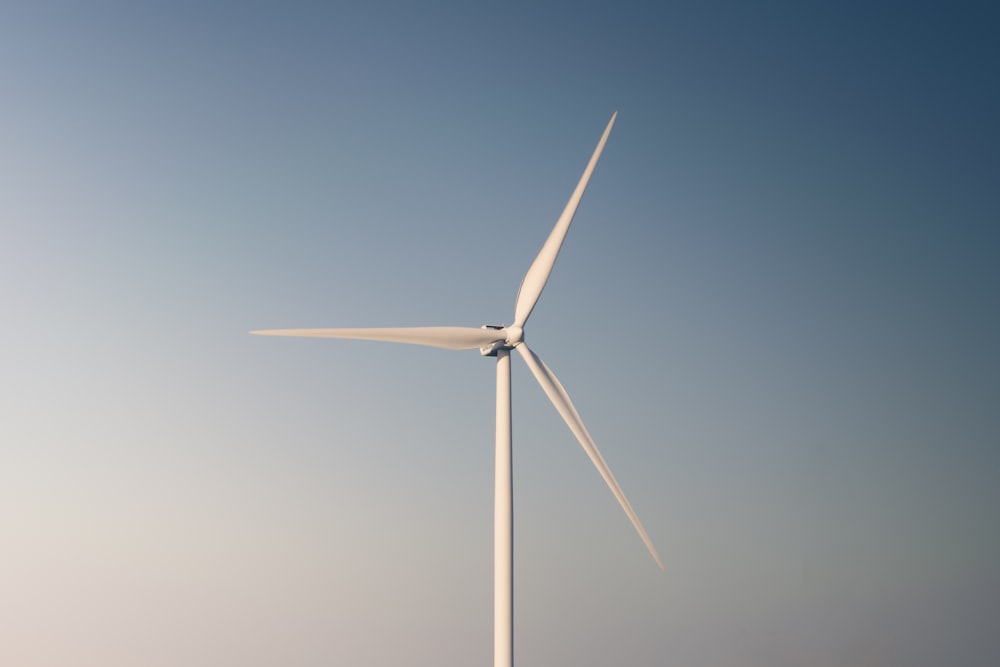 a wind turbine in the middle of a blue sky