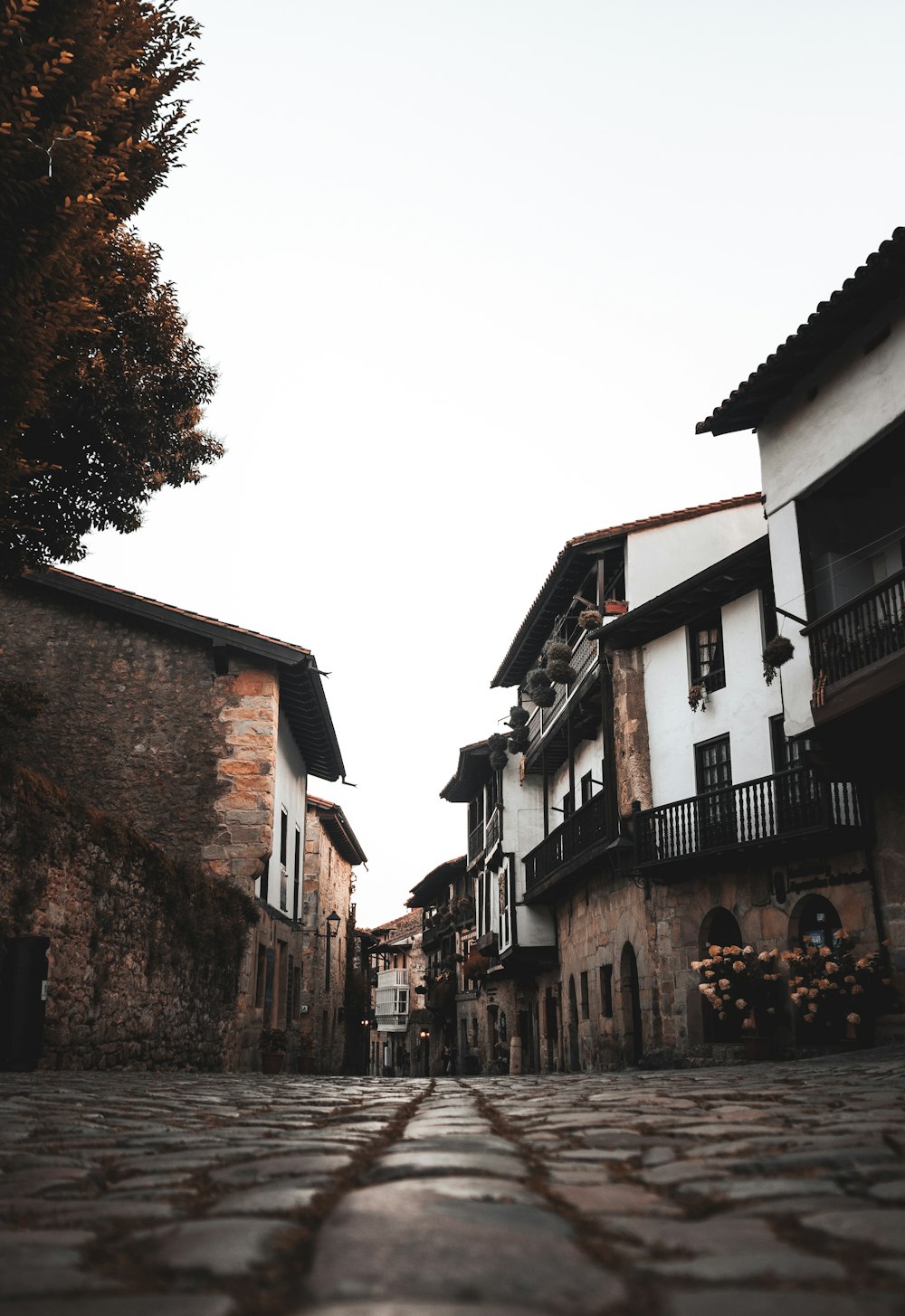 a cobblestone street lined with old buildings