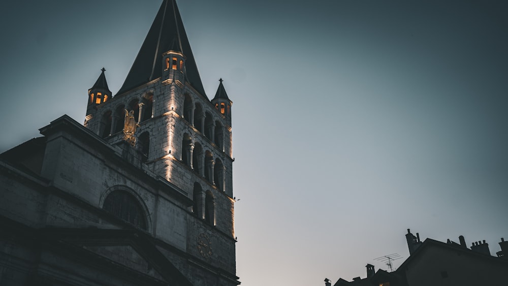 a church steeple lit up at night