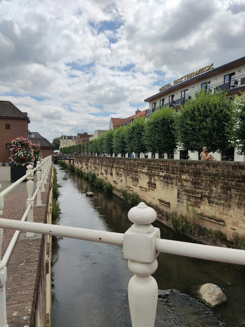 a river running through a city next to tall buildings