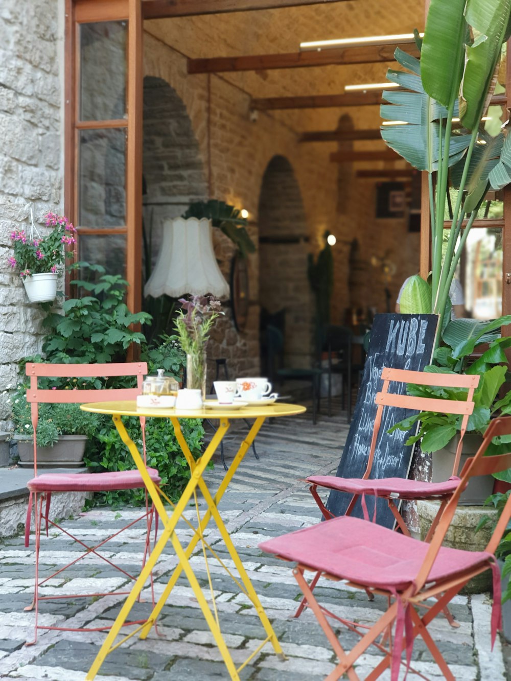 two chairs and a table outside of a building