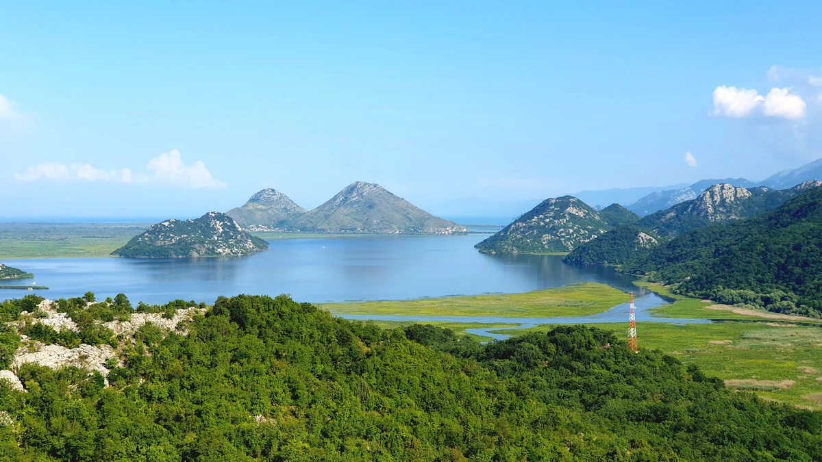 An Albanian lake surrounded by green mountains