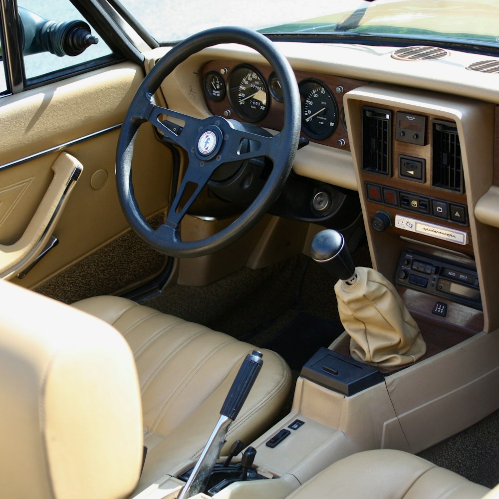 the interior of a car with a steering wheel and dashboard