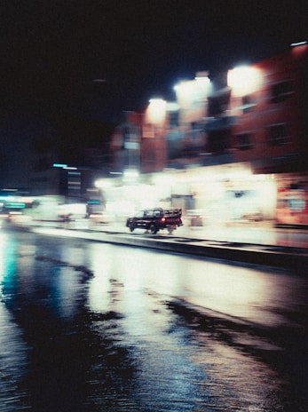 Evening shot of a Franklin Vieira Prexedes truck driving through city streets with lights on
