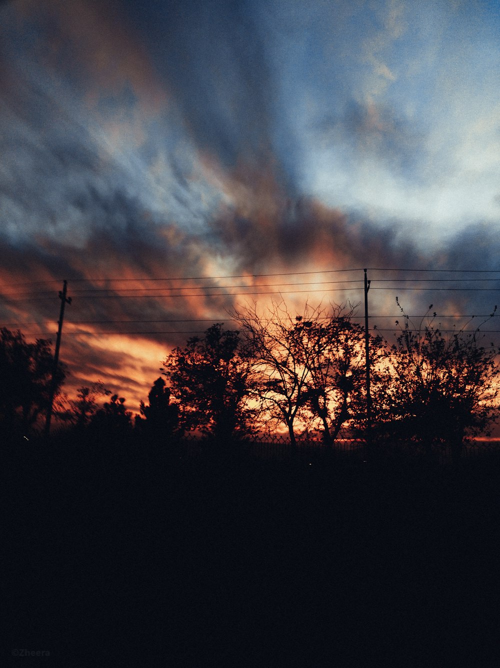 the sun is setting behind the clouds in the sky