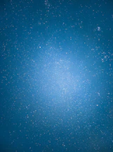 A serene cosmic night sky with shimmering stars and subtle sacred geometry patterns glowing softly.