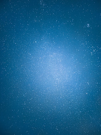 A starry night sky projected on a wall behind an astrology-themed event setup.