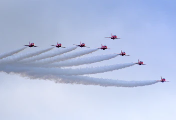 a group of planes flying in formation in the sky