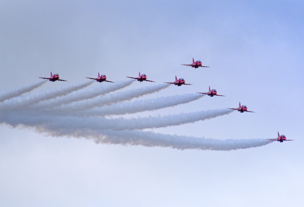 a group of planes flying in formation in the sky