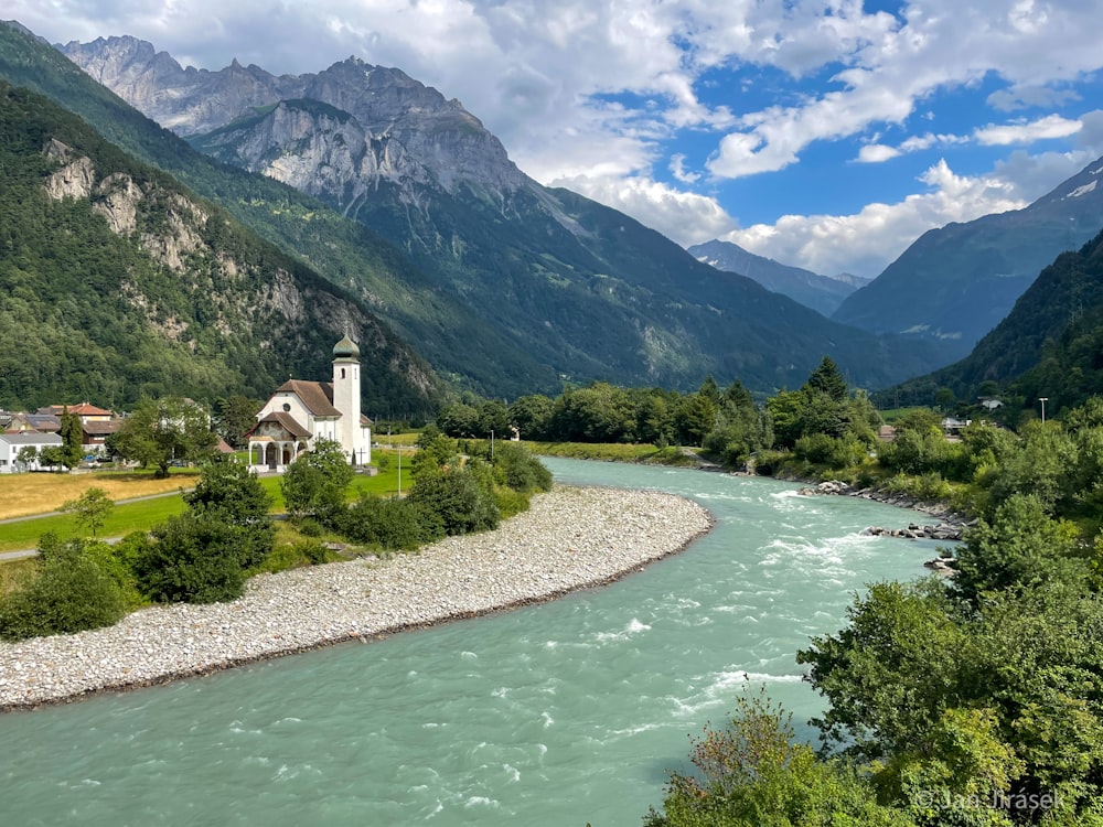 a river running through a lush green valley