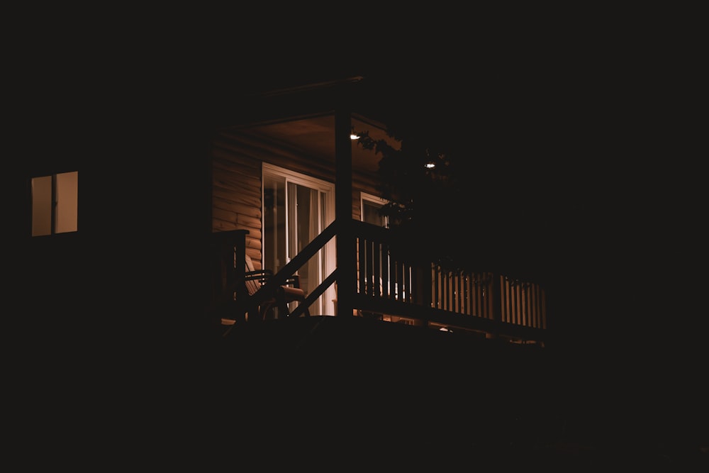 a dark picture of a porch at night