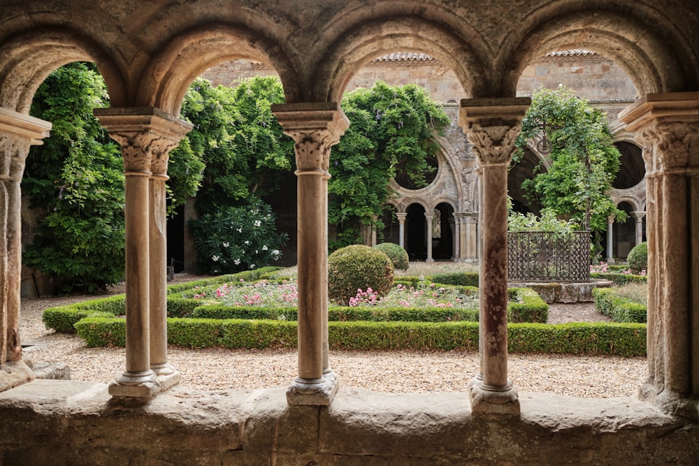 a view of a garden through an arch in a building