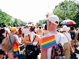 An outdoor scene of a community event hosted by double rainbow @ autistry studios with colorful decorations.
