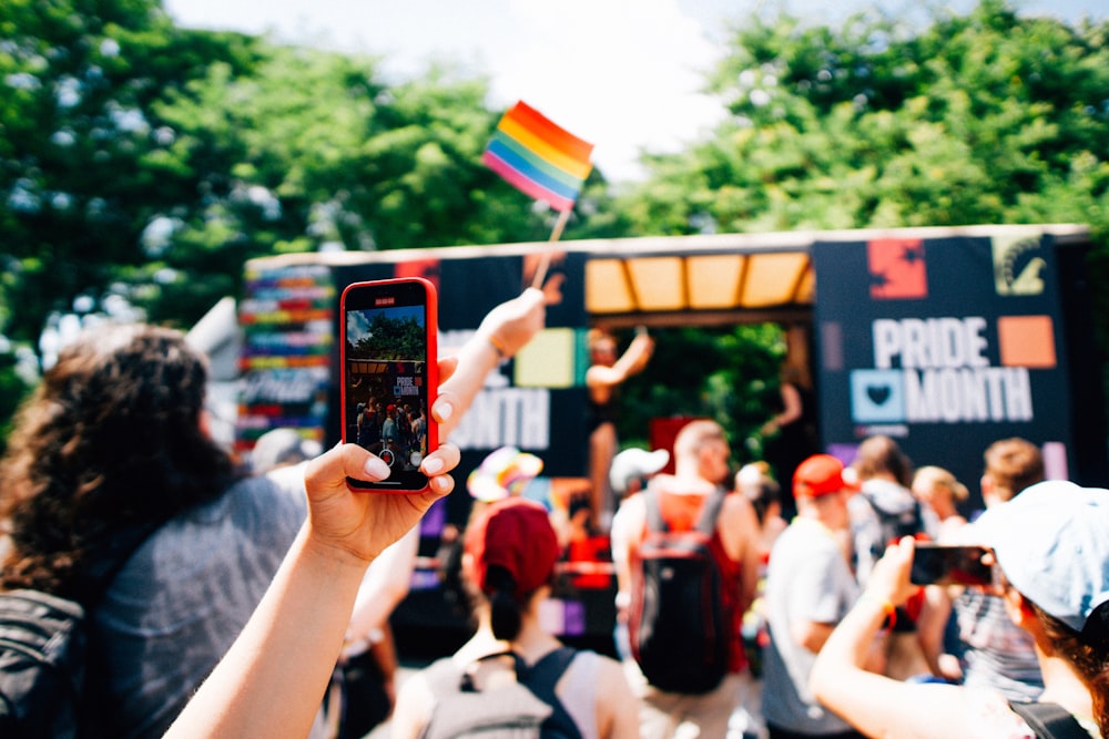 a group of people taking pictures with their cell phones