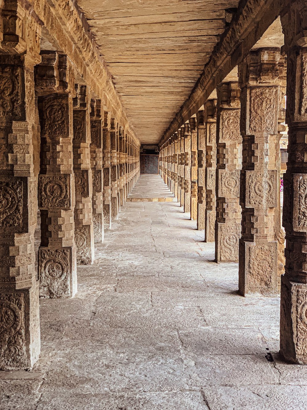 a row of pillars with carvings on them