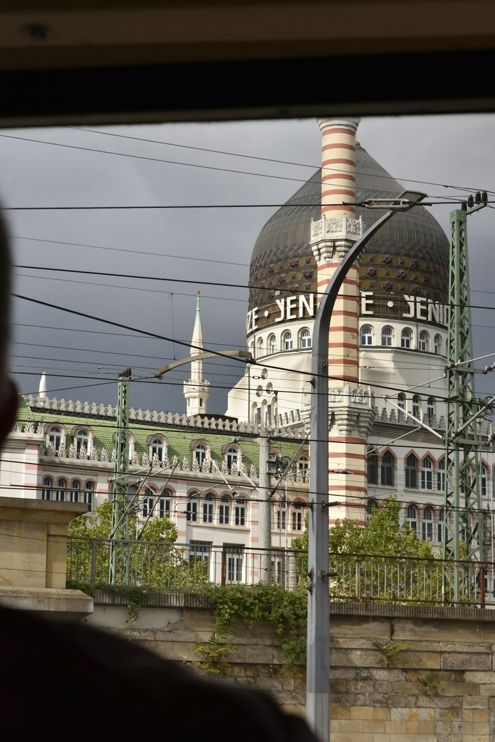 a view of a building from a train window