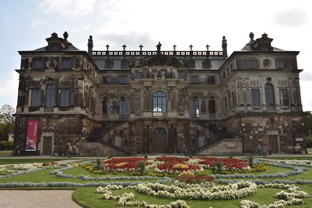 a large building with a garden in front of it