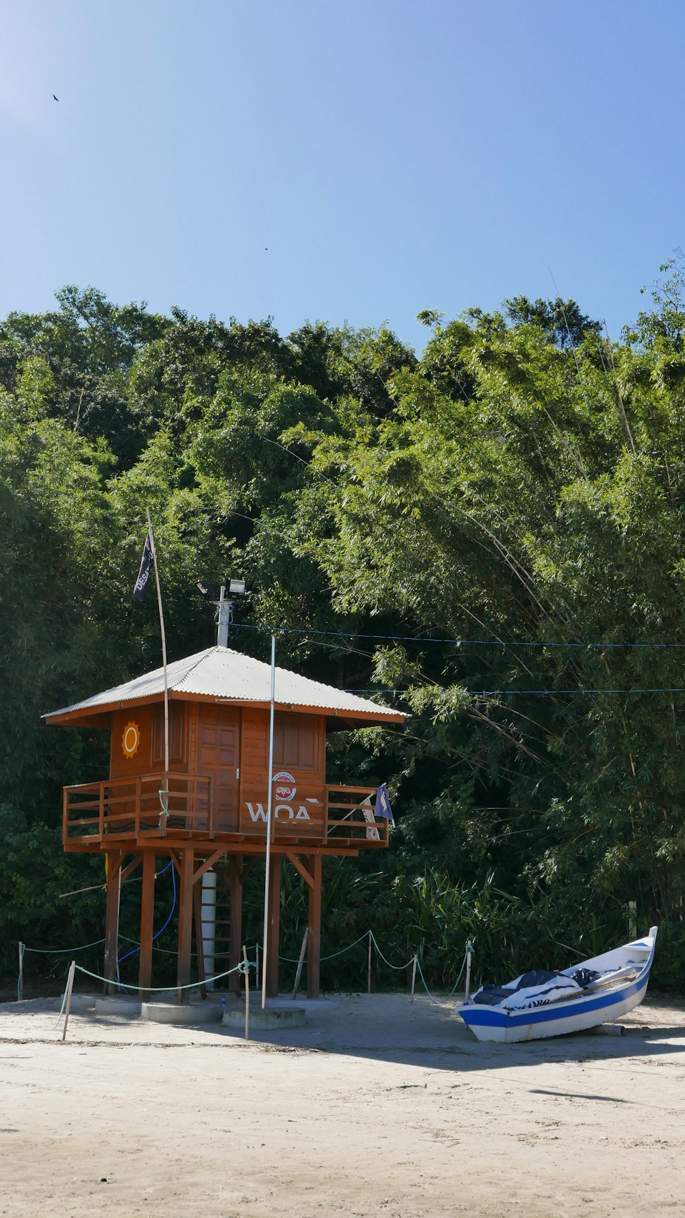 a boat is parked in front of a wooden tower