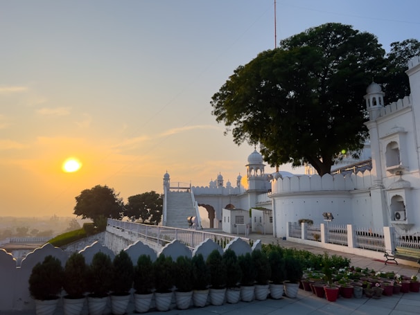 A serene landscape showcasing a Baha'i temple at sunset.