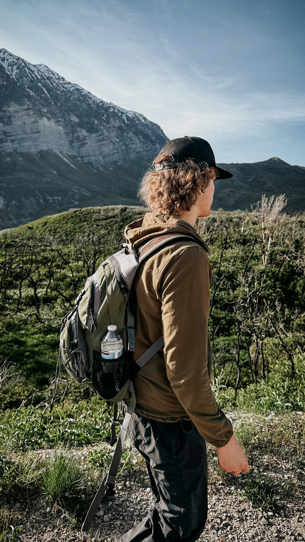 a man with a backpack is walking in the mountains