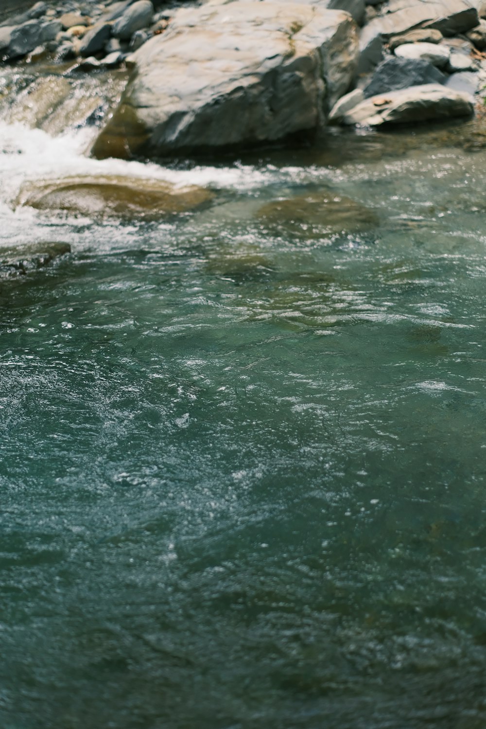 a man standing on a rock in a river