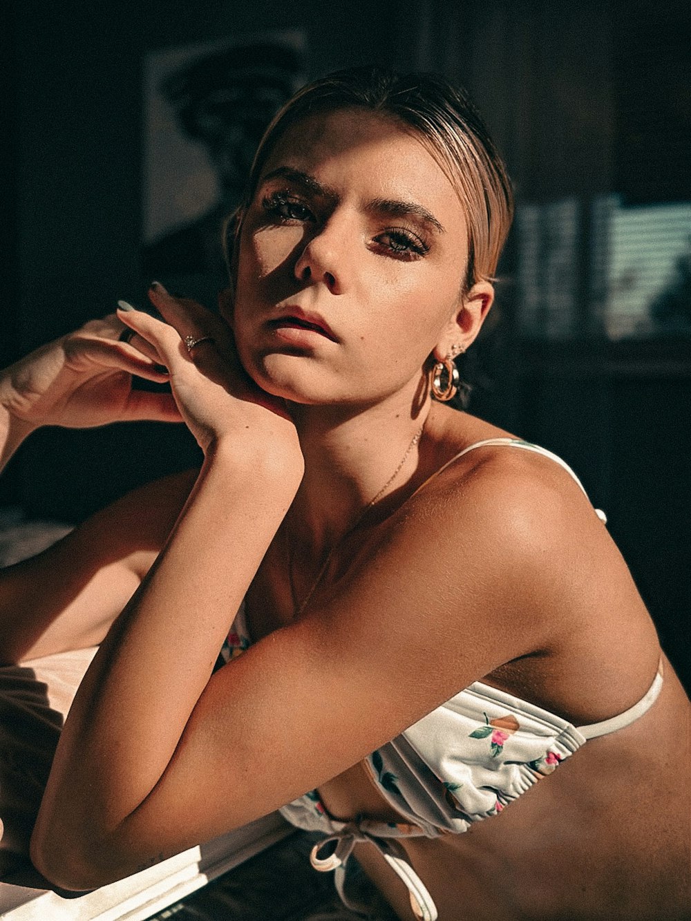 a woman sitting in a chair with her hand on her chin