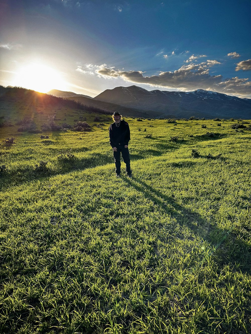 a man standing on a lush green field