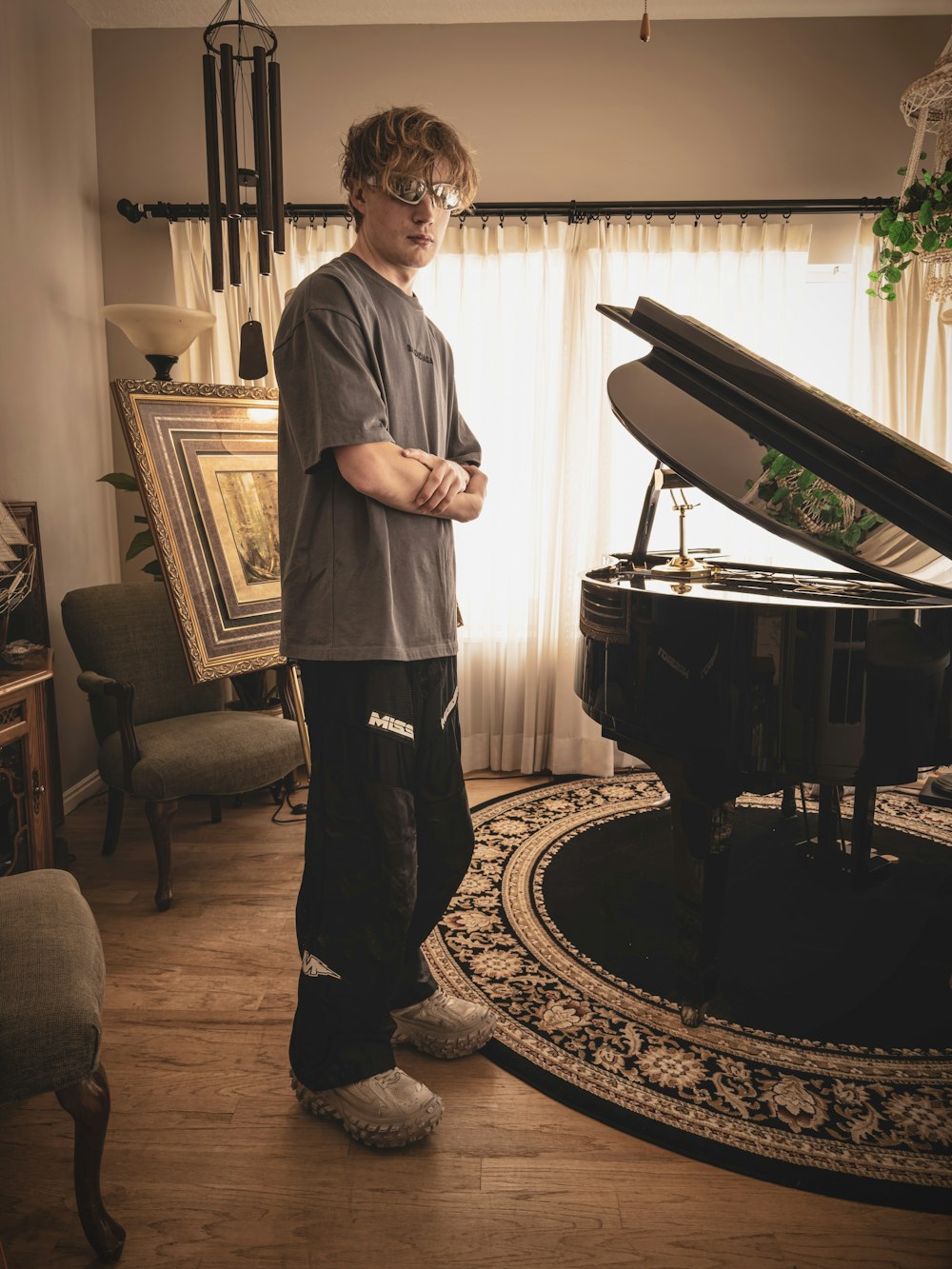 a man standing in front of a piano in a living room
