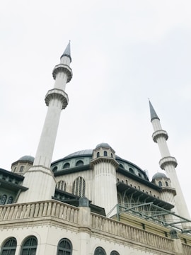 A large mosque featuring multiple tall minarets and a grand central dome. The structure is ornate, with detailed architectural elements and arched windows.