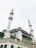 A large mosque featuring multiple tall minarets and a grand central dome. The structure is ornate, with detailed architectural elements and arched windows.