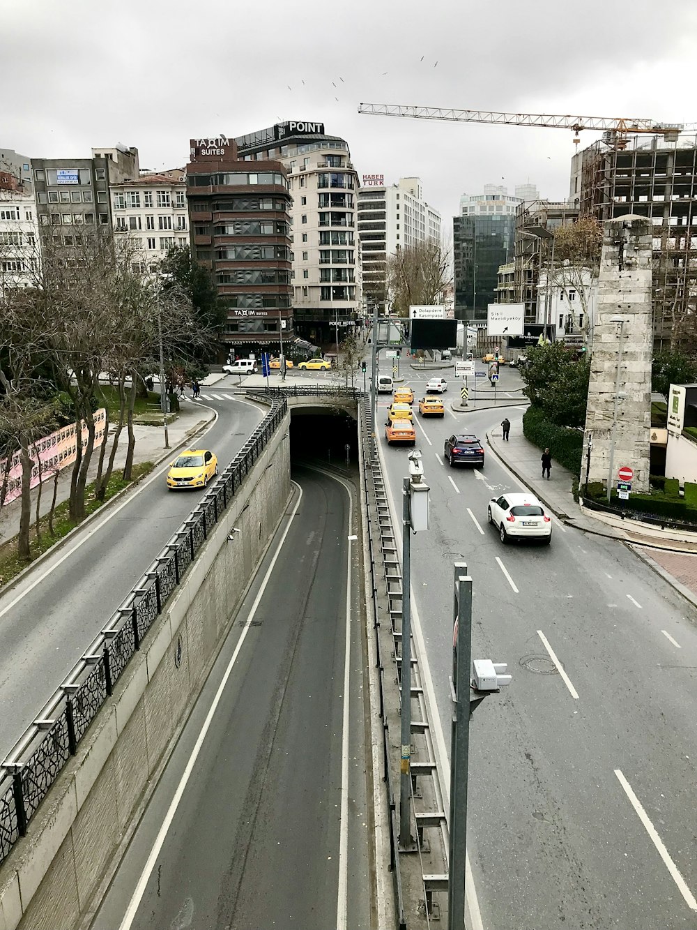 a city street filled with traffic next to tall buildings