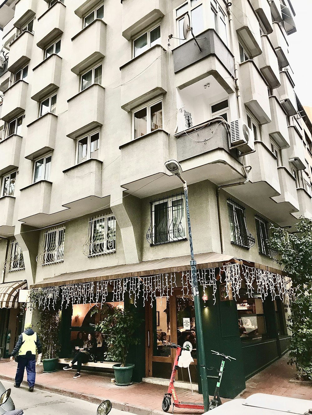 a tall building with lots of windows next to a street